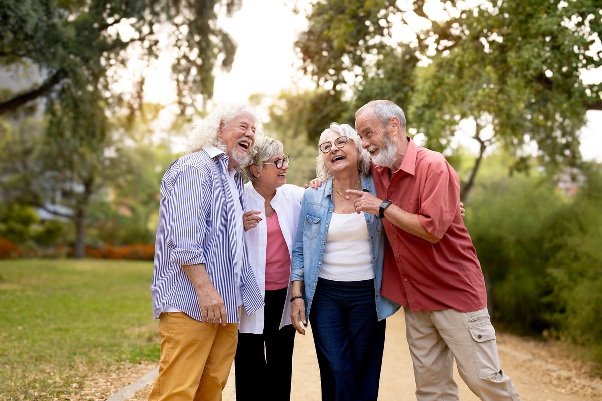 A group of older adult friends enjoying a walk together outdoors